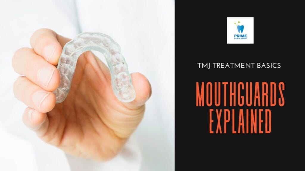 Close-up of a hand holding a mouthguard for TMJ treatment.